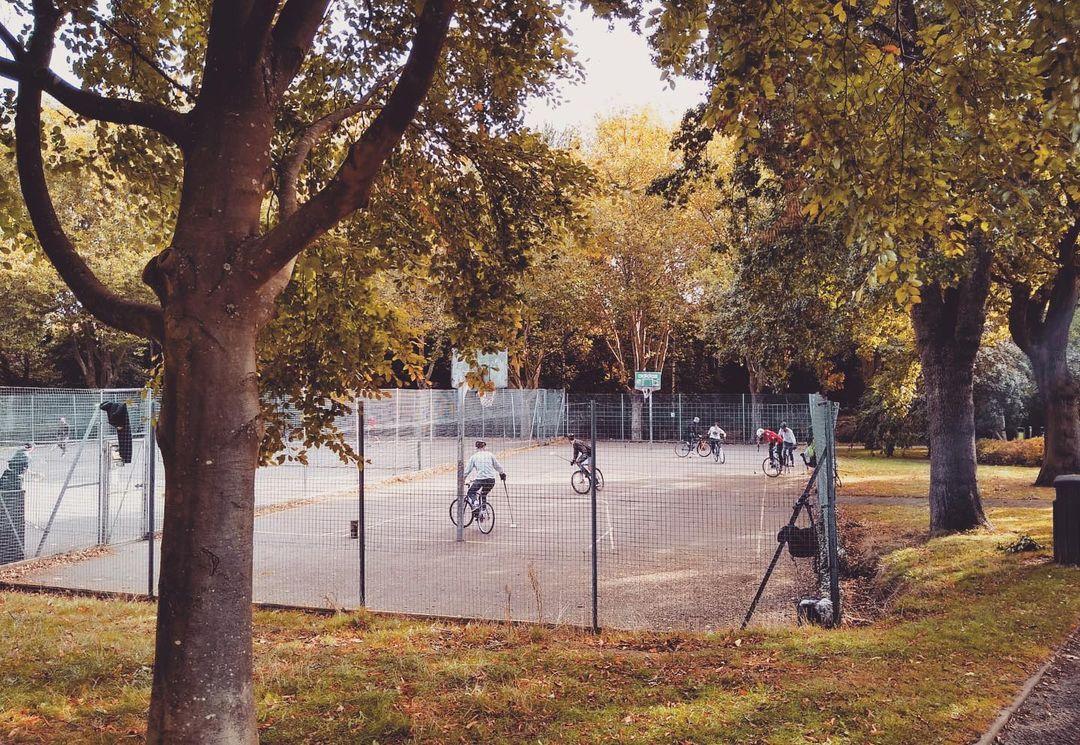 People playing bike polo at the court in Cotteridge Park, Birmingham